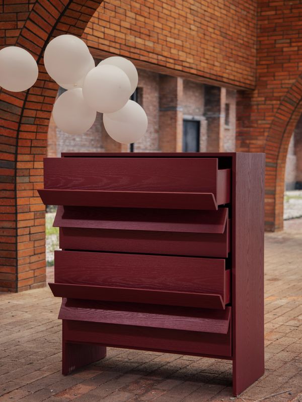 Tilt Chest with angled burgundy drawer fronts